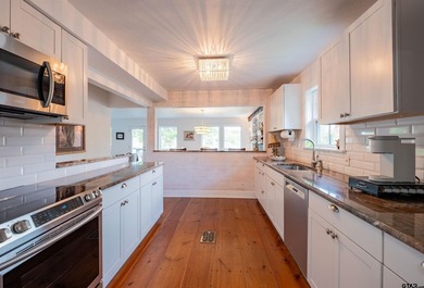 Main lake waterfront with private dock, updated interior, and - photo 12