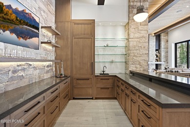 This newly completed estate sits on one of the premier homesites