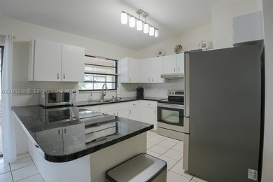 This charming 1988-built residence offers three bedrooms and two - photo 6