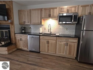 Comfortable in all seasons, this 2-bedroom condominium has