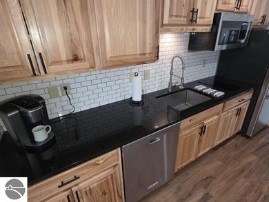 Comfortable in all seasons, this 2-bedroom condominium has