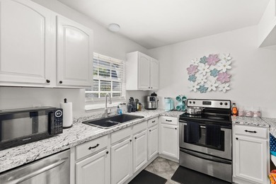 This renovated 2-bedroom, 2-bath condo has a newer roof (2022) - photo 6