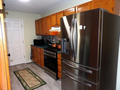 Well-maintained property featuring a 14' RV carport with hookups - photo 6