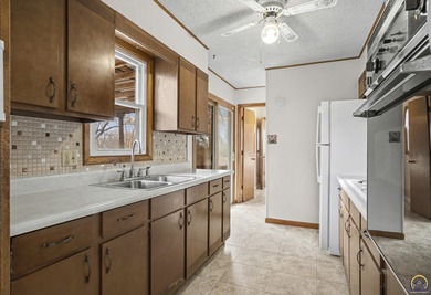 Welcome to this charming ranch-style residence that perfectly