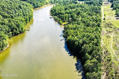 Sitting on the Tennessee River, this 8/4 +- acre tract, gently - photo 7