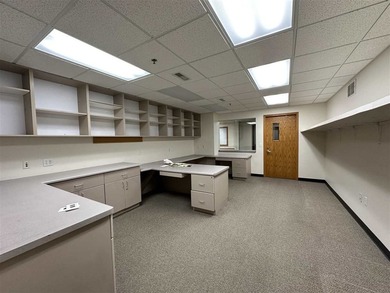 This large office offers 14 private offices, enclosed reception - photo 11