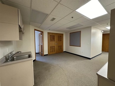 This large office offers 14 private offices, enclosed reception - photo 12