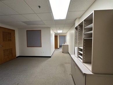 This large office offers 14 private offices, enclosed reception - photo 13