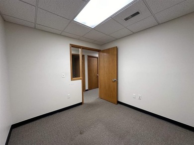 This large office offers 14 private offices, enclosed reception - photo 32