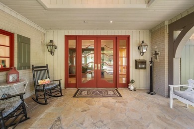 Nestled far back from the street on a peaceful 7.44-acre lot