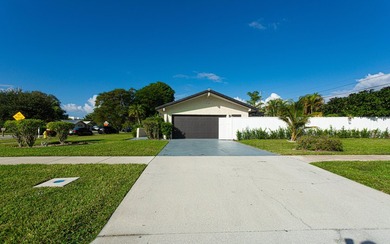Tucked away on an oversized corner lot in the sought-after - photo 2