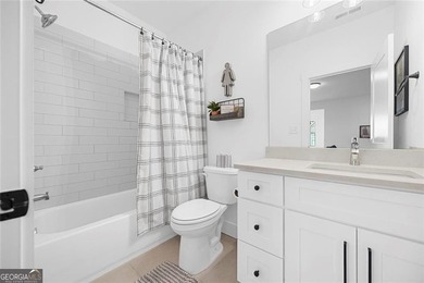 Tucked in the heart of Bridgemill, this luxury townhome lives - photo 23