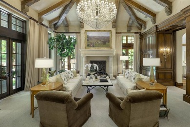 Rising behind a circle drive and flanked by Mediterranean