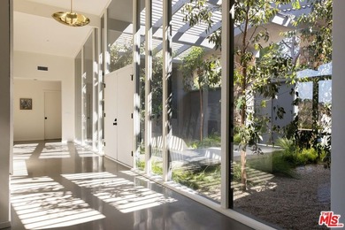 Tucked in an exclusive pocket of the Hollywood Hills, this - photo 7