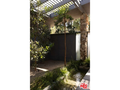 Tucked in an exclusive pocket of the Hollywood Hills, this - photo 9