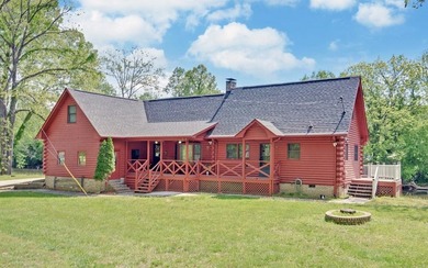 Wake up where the river is the main event. This true log cabin - photo 3