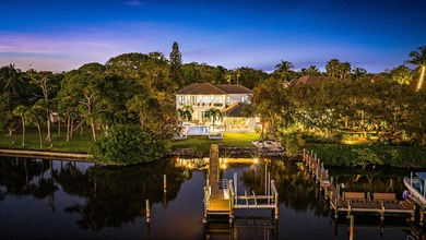 Nestled on nearly one acre of pristine riverfront, this - photo 2