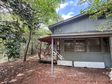 Tucked among the tall trees on beautiful Lake Franklin in the - photo 18