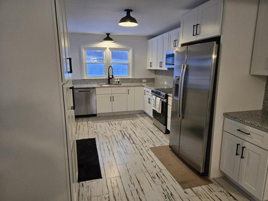 Kitchen has been remodeled, with new, cabinets, flooring and - photo 12