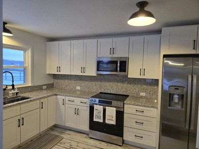 Kitchen has been remodeled, with new, cabinets, flooring and - photo 13