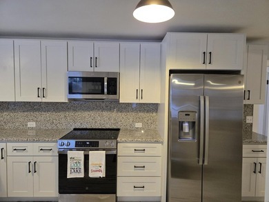 Kitchen has been remodeled, with new, cabinets, flooring and - photo 14