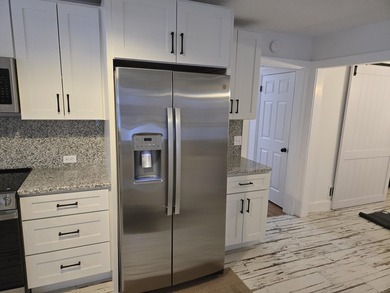 Kitchen has been remodeled, with new, cabinets, flooring and - photo 15