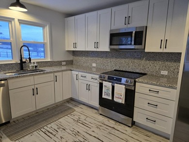Kitchen has been remodeled, with new, cabinets, flooring and - photo 16
