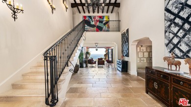 Enter through a grand metal, glass, and wood front door framed - photo 9
