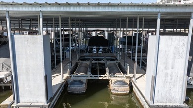 Huge screened deck, 12x32 boat slip with 8,000 lb lift, and rare - photo 32