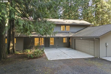 Tucked away on nearly 7 acres of serene, forested privacy, this - photo 1