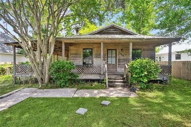 Charming wood cottage with a metal roof and fully fenced yard in - photo 1