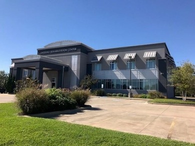 The first floor has a vestibule entrance with a stairwell and