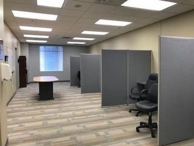 The first floor has a vestibule entrance with a stairwell and