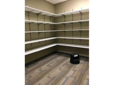 The first floor has a vestibule entrance with a stairwell and