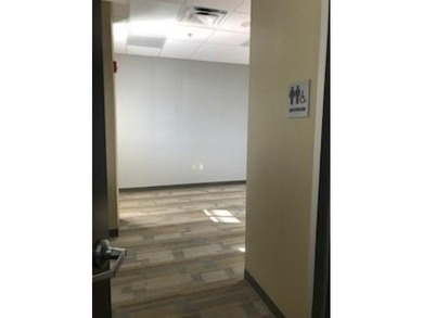 The first floor has a vestibule entrance with a stairwell and