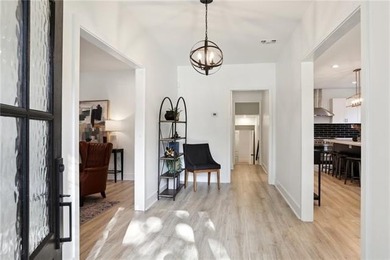 Thoughtfully renovated in 2021, this Canal Blvd residence blends - photo 3