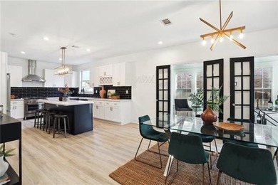 Thoughtfully renovated in 2021, this Canal Blvd residence blends - photo 7