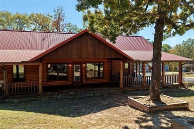 STUNNING LOG CABIN LAKE HOME WITH GUEST HOUSE, SHOP AND BOAT
