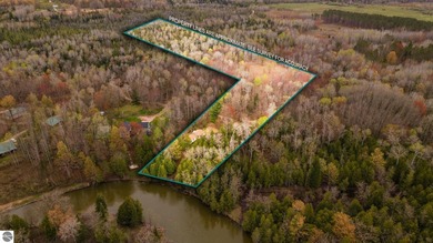 Tucked away on 8+ wooded acres along the Manistee River and - photo 3