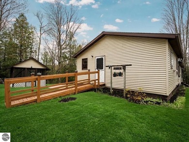 Tucked away on 8+ wooded acres along the Manistee River and - photo 4