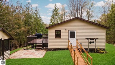 Tucked away on 8+ wooded acres along the Manistee River and - photo 5