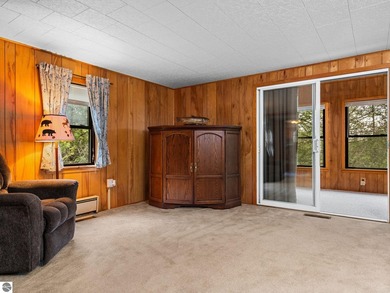 Tucked away on 8+ wooded acres along the Manistee River and - photo 8
