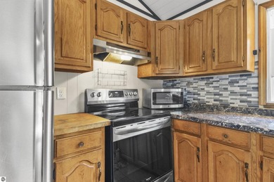 Enjoy beautiful views of Stoneledge Lake from the spacious back - photo 7