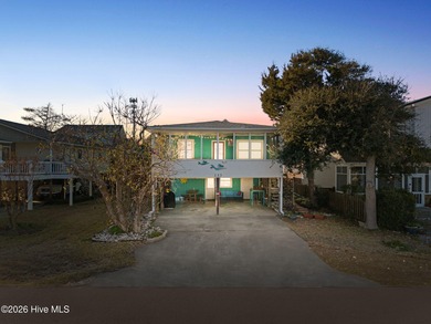 Tucked along a quiet street, this charming coastal cottage
