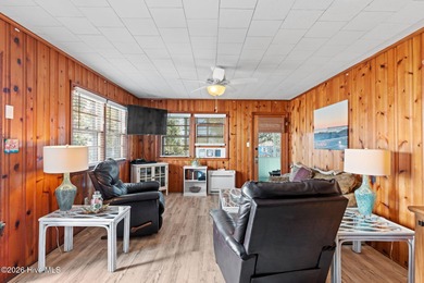 Tucked along a quiet street, this charming coastal cottage