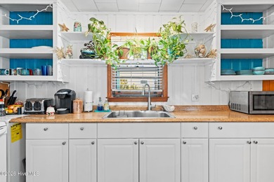 Tucked along a quiet street, this charming coastal cottage