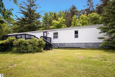 Set on 10 acres just outside Manton, this thoughtfully updated - photo 3