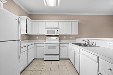 Welcome to this charming 2-bedroom, 2-bathroom first-floor condo