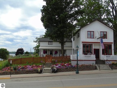 Built in 1886 overlooking Fife Lake, this historic triplex - photo 2