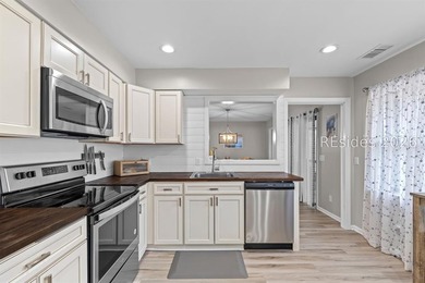 This beautifully updated residence offers laminate wood flooring - photo 16